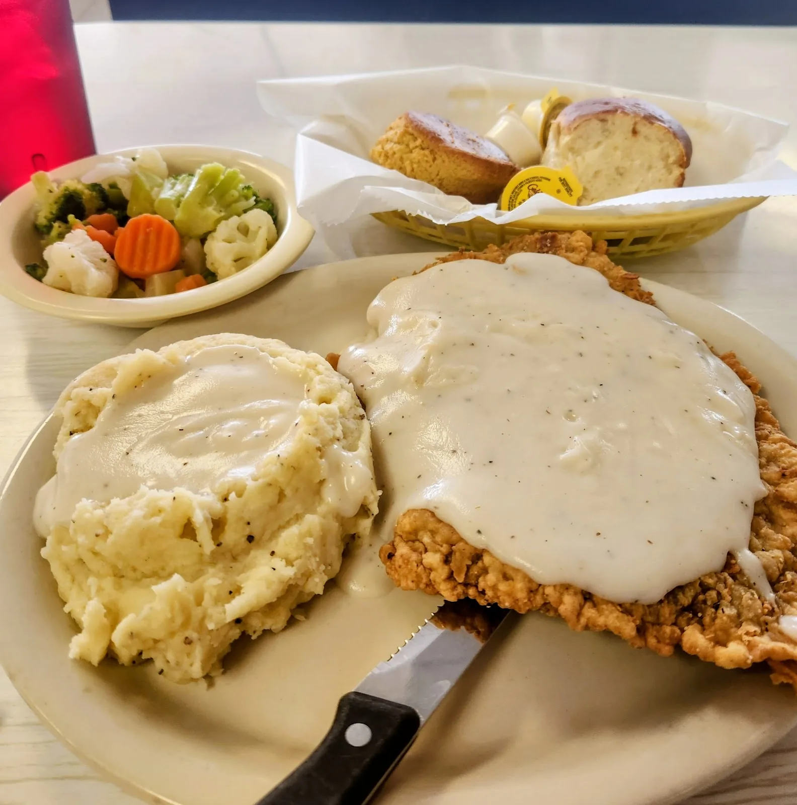 Chicken fried steak with cream gravy, mashed potatoes and mixed vegetables at City Cafe in South Houston