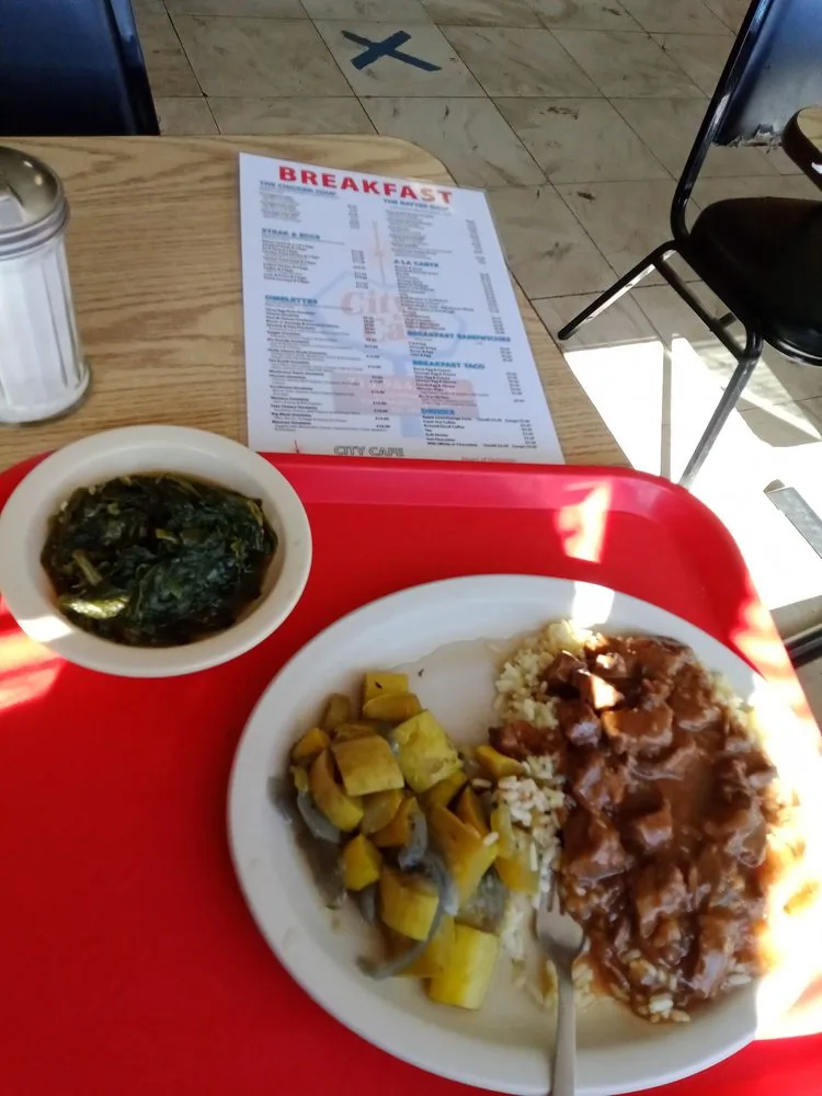 Beef tips over rice with vegetable sides, a steam table plate at City Cafe in South Houston