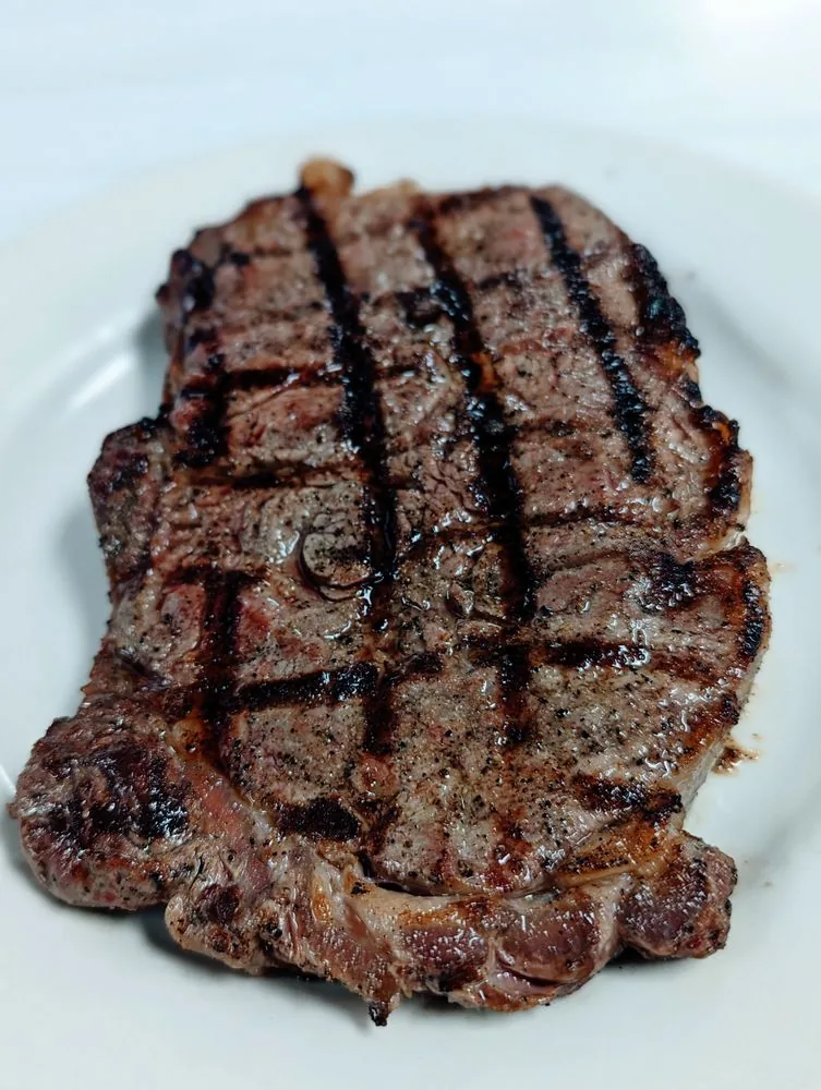 A cooked steak plate with sides at City Cafe in South Houston