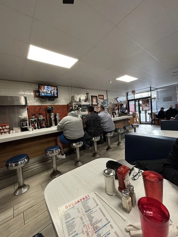 Counter seating with swivel stools along the service line at City Cafe in South Houston
