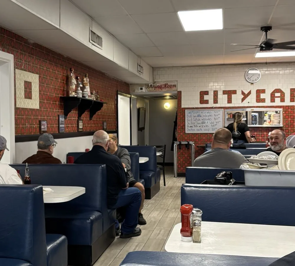 Regulars in the blue booths at City Cafe in South Houston during the morning rush